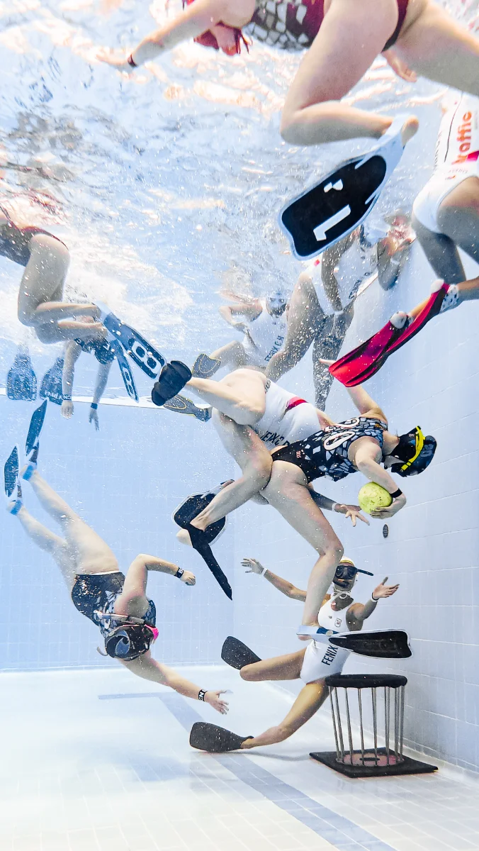 Team advancing toward the buoy during an underwater rugby match